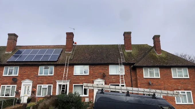 Scaffold ladders and solar panel work on a terraced roof
