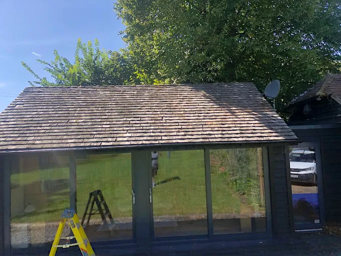 Cedar shingle roof on a garden studio in Sussex