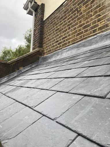New natural slate roof with lead flashing